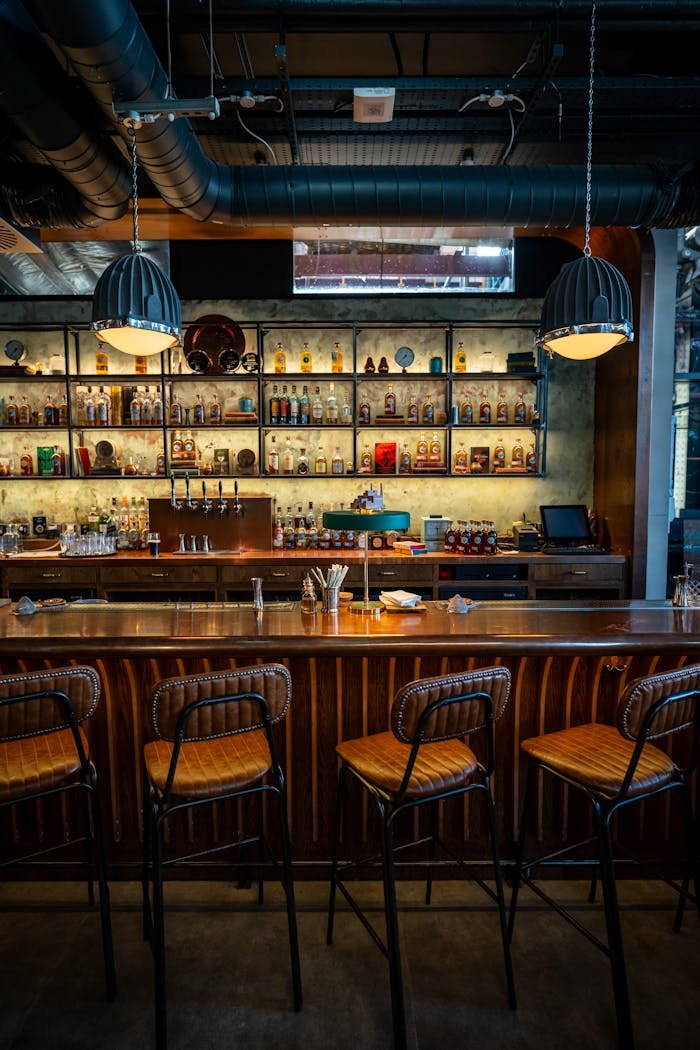 Warm ambient lighting inside a vintage-style Irish bar with a stocked backlit shelf.