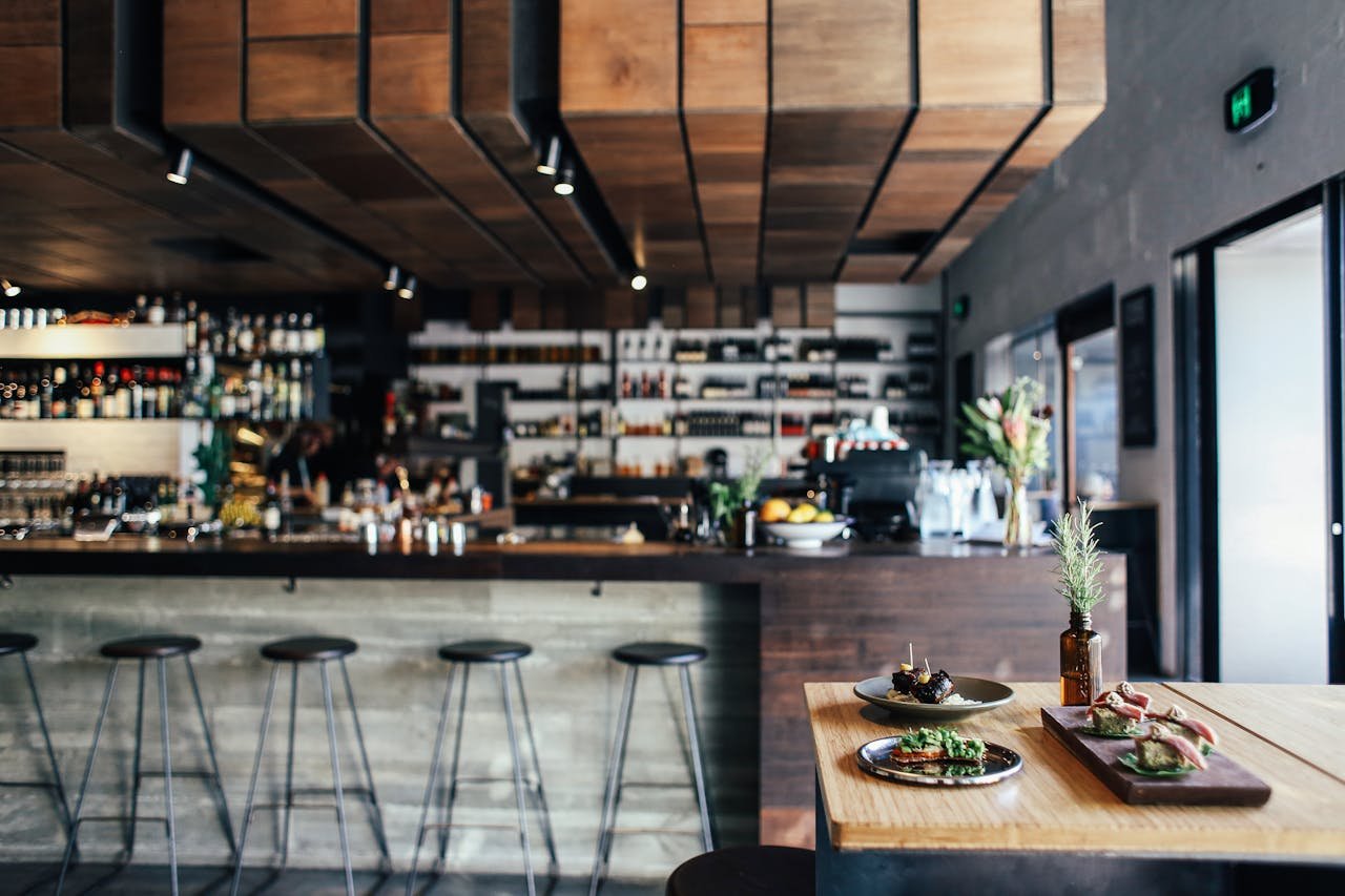 Cozy restaurant with wooden decor and food on a table, inviting atmosphere.
